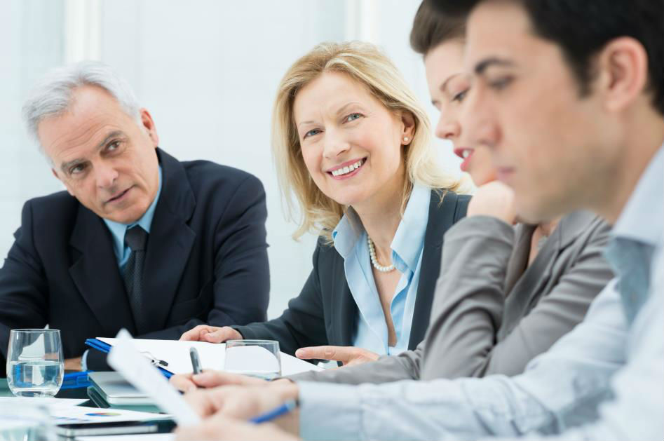 /Woman smiling with coworkers.jpg